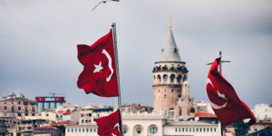 Turkish flags waving in front of Galata Tower, symbolizing the rich cultural and educational heritage of Turkey.