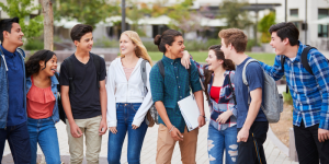 International students smiling and talking while standing together on a university campus in Türkiye.