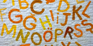 A wall painted with colorful letters of the Turkish alphabet, representing visual language learning