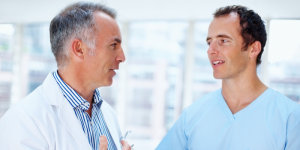 Two doctors discussing healthcare options in a clinical setting