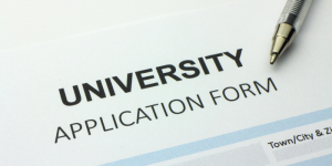 A close-up of a university application form and pen, indicating the admission process.